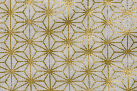 Highly detailed all over background texture of traditional japanese gold and white hemp leaf shaped pattern design textile in synthetic fabric.の写真素材