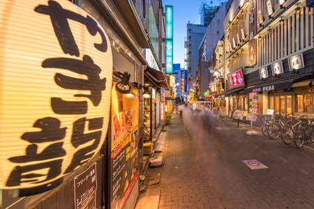 TOKYO, JAPAN - AUGUST 21 2018: Illuminated entrance gate to the Sunshine Central Street connecting the east exit of Ikebukuro station with yakitori and sushi restaurants, shops, game center and cinemas leading to the famous otaku's otome road.のeditorial素材