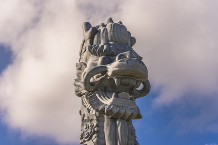 Close-up on the stone dragon head of the pillars that greet cruise ship visitors close to the Naha Port Cruise Terminal dock, symbol of sister cities Naha and Fuzhou in China.の写真素材