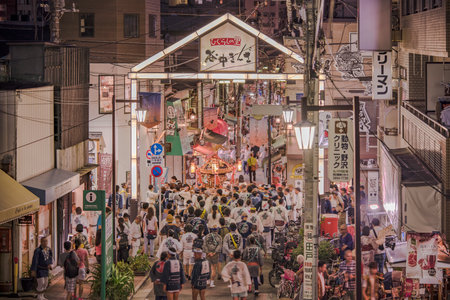 TOKYO, JAPAN -August 25 2018: Japanese bear Shinto shrine mikoshi on their shoulders during the Obon festival in the retro old-fashioned street shopping Yanaka Ginza famous as a spectacular spot for sunset Yuyakedandan stairs which means Dusk Steps at Nisのeditorial素材