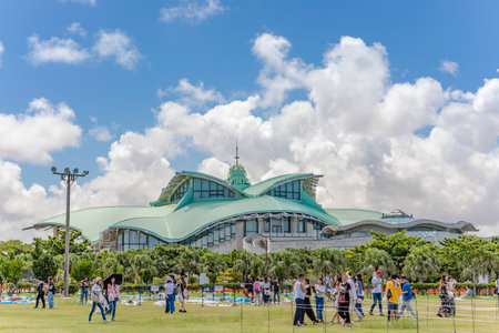 GINOWAN, JAPAN - September 16 2018: Building of Okinawa Convention Center decorated with palm trees near the tropical beach of Ginowan Cityのeditorial素材