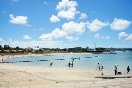 Okinawa, Japan - September 14, 2018: Beach umbrellas and palm trees on the beach in Chatan City in the American Village of Okinawa island in Japan.のeditorial素材