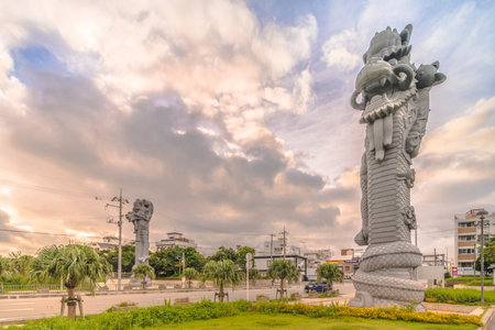 Naha, Japan - September 15, 2018: Sunrise on the giant stone dragon head of the pillars that greet the ship Naha Harbor Cruise Terminal dock, Naha and Fuzhou symbol of sister cities in China.のeditorial素材