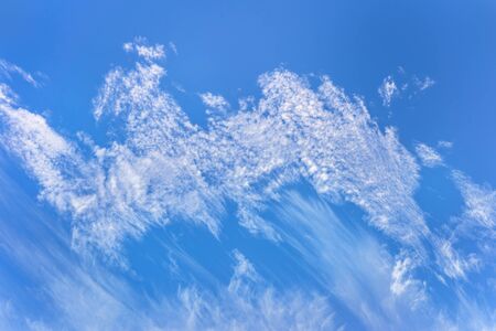 blue sky and dragon shaped cirrus clouds over the sky of tokyo.の写真素材