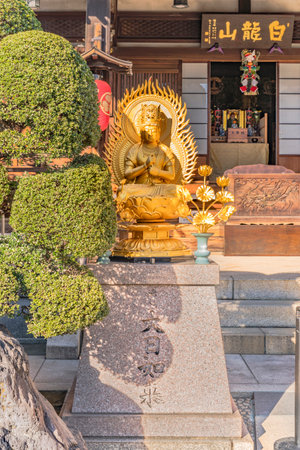 Tabata, Japan - January 03 2019: Small golden statue depicting the Buddha Dainichi Nyorai which is the main deity of Shingon Buddhism in Tabata Togakuji temple in Tokyo.のeditorial素材