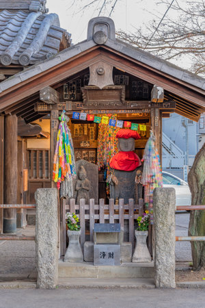 Shrine dedicated to Jizo statues symbol of filial piety to protect children and decorated with thousnd cranes origami in the Tennoji Temple of Yanaka cemetery.のeditorial素材