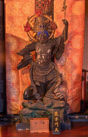 TOKYO, Japan- JANUARY 07 2020: Wooden statue depicting one of the Four Heavenly Kings buddhist deity of Bishamonten depicted holding a lance in the Tendai Buddhism Gokokuin temple in the Ueno district of Tokyo.のeditorial素材