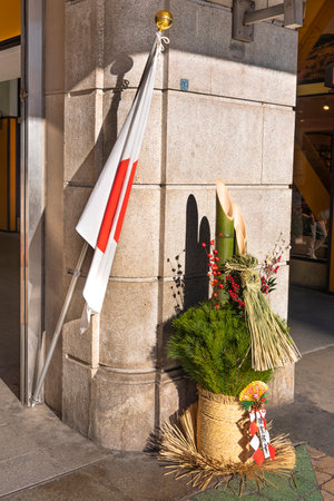 ueno, japan - january 07 2020: Front of Ueno Station a major railway station in Tokyo decorated with national flag and traditional New Year decoration called a 'kadomatsu' ('gate pine') made of ume flowers, pine boughs, and bamboo.のeditorial素材