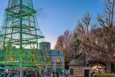 ueno, japan - january 02 2020: Bronze statue of the Japanese historical figure the samurai Saigo Takamori accompanied by one of his dogs in the Ueno park illuminated with garlands for christmas at sunset.のeditorial素材