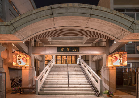 tokyo, japan - march 12 2020: Modern concrete entrance illuminated with paper lanterns of the Jozaiji temple of the Nichiren Buddhist sect in Ikebukuro district, Tokyo, Japan.のeditorial素材