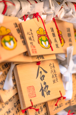 tokyo, japan - march 02 2020: Shinto wooden plaques decorated with a radish and drawstring bag for...
