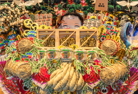tokyo, japan - march 18 2020: Abundance of decorations in the effigy of deities and lucky charms of Japanese folklore like Ebisu god of fishing, Daikokuten god of harvests, Otafuku goddess of mirth on a giant Engi Kumade which means Auspicious Rake sold eのeditorial素材