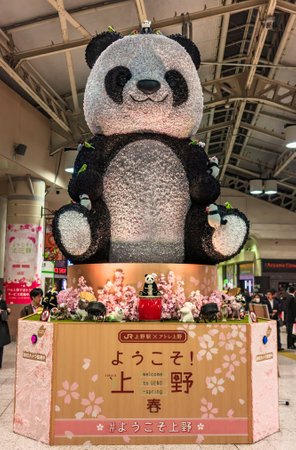 tokyo, japan - march 25 2020: Exhibition of a giant panda in cherry blossoms to celebrate the Hanami Spring Festival in Ueno station in Tokyo.のeditorial素材
