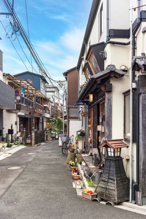 tokyo, japan - march 30 2020: Traditional Japanese wooden houses from the Showa era rehabilitated into retro Old-Fashioned restaurant in the quiet nostalgic and old town neighbourhood of Yanaka Ginza district and decorated with religious Ema plaques.のeditorial素材