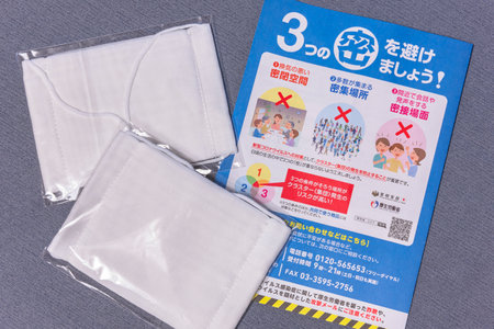 tokyo, japan - may 20 2020: Cloth masks and leaflet promoting social distancing sent by Japanese govt of Abe Shinzo to cope with the chronic shortage and fight the spread of coronavirus (COVID-19).のeditorial素材