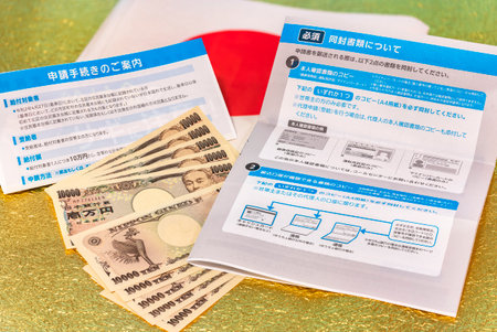 tokyo, japan - june 01 2020: Bank notes and documents for application procedure of special fixed 100000 yen benefit sent by the Japanese govt of Abe Shinzo to fight the unemployment caused by COVID-19.のeditorial素材