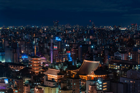 Aerial night panoramic view of buddhist temple halls and pagoda light-up in the Asakusa district of Tokyo.のeditorial素材