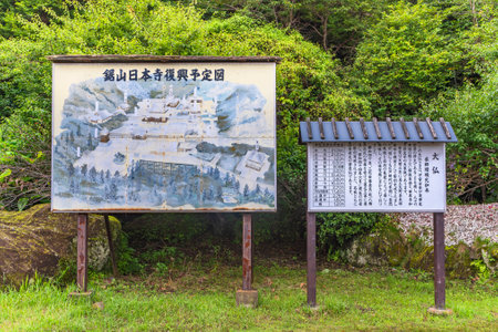 chiba, japan - july 18 2020: Information panel and painted map of Nihonji Buddhist temple at Mount Nokogiri stone quarry explaining the origins of the giant buddha Daibutsu Yakushi Ruriko Nyorai.