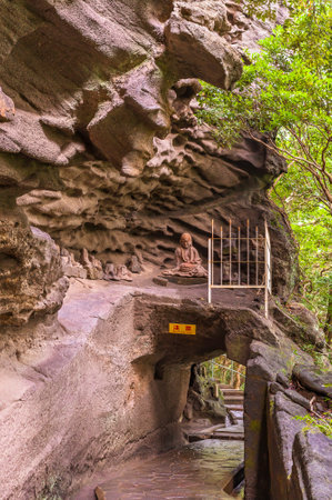 chiba, japan - july 18 2020: Buddhist statue of the monk kÅ«kai created by Jingoro Eirei Ono in the cavity of Gomakutsu or fiery cave above a tunnel of the hiking path of the Mount Nokogiri quarry.のeditorial素材