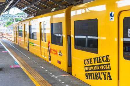 kanagawa, japan - july 19 2020: Yellow train of Yokosuka line wrapped with advertising stickers of...