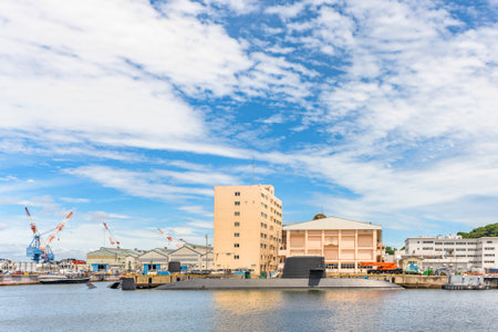yokosuka, japan - july 19 2020: Submarine Takashio ss-571 of Japan Maritime Self-Defense Force berth in Yokosuka naval port with a valiant-class harbor tug Puyallup YT-806 of the United States Navy.のeditorial素材