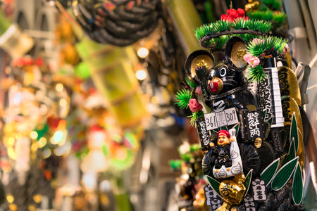 asakusa, japan - november 08 2019: Auspicious rake or engi kumade ornate with black mouses symbol of balance in the black for the mouse year 2020 on sale in the Tori-no-Ichi Fair at Ootori shrine.のeditorial素材