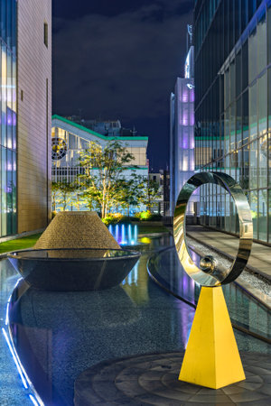 tokyo, japan - december 01 2020: Fountain and modern art objects in the inner garden of Shinjuku Lumine building between the glassed facades of the NEWoMan mall and the JR Shinjuku Miraina Tower.のeditorial素材