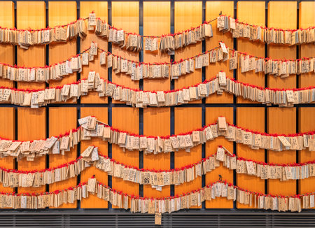 tokyo, japan - january 02 2020: Shinto wooden plaques depicting airline tickets with at back handwritten prayers of worshipers on the wall of Omatsuri-hiroba in Haneda Airport International Terminal.のeditorial素材