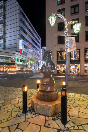 ikebukuro, japan - december 31 2020: Public monument shaped in treble clef with the lyrics of song "Flower of Hope" dedicated to Toshima citizens by Makoto Saeki on Sunshine Street at night.のeditorial素材