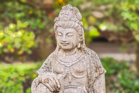 tokyo, japan - april 12 2020: Close up on the stone statue depicting the bust of the Japanese bodhisattva Monju Bosatsu symbolizing wisdom and intelligence in the Buddhist Togakuji temple of Tabata.のeditorial素材