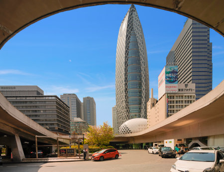 tokyo, japan - April 07 2019: Cars traffic at the West Underground Entrance Plaza of Shinjuku station with taxi stands and the iconic skyscrapers of Mode Gakuen Cocoon Tower and Shinjuku L Tower.のeditorial素材