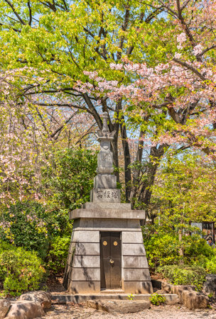 tokyo, japan - march 23 2021: Buddhist stupa Shakyoto erected in 1979 commemorating the 1300 anniversary of the death of the monk Shandao in the Zojoji Temple surrounding by cherry blossoms branches.のeditorial素材