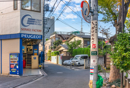 tokyo, japan - may 05 2021: Service factory garage of foreign cars of the french brand Peugeot in a neighborhood street of mukojima district in sumida city in front of the mukojima hyakkaen gardens.のeditorial素材