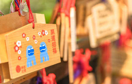 tokyo, japan - May 03 2021: Shinto wooden Ema votive plaques adorned with cute Japanese komainu lions in the Akagi shrine of Kagurazaka adorned with plum flowers illustrations and the word good luck.のeditorial素材