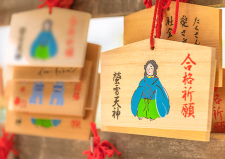 tokyo, japan - may 03 2021: Shinto wooden Ema votive plaques adorned with Japanese poet Keisetsu tenjin god of studies in the Akagi shrine of Kagurazaka adorned with the word Pray for success to examsのeditorial素材