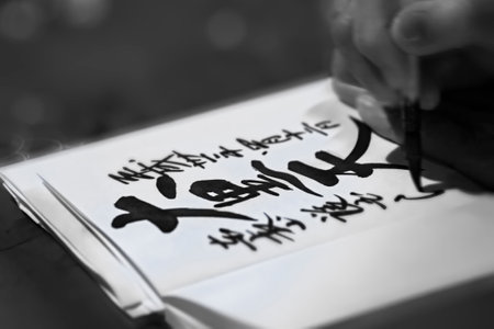 tokyo, japan - april 12 2019: Black and white photography of a close up on a hand writing in calligraphy the Japanese name of Daikokuten the deity of wealth which is one of the seven lucky gods.のeditorial素材