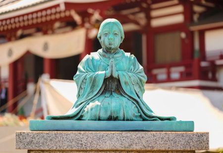 tokyo, japan - june 10 2021: Bronze statue oxidized by patina of sect founder Jodoshu Honen named Seishimaru at the age of nine praying at two hands when he became monk as his late father wished.のeditorial素材