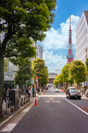 tokyo, japan - april 06 2019: Traffic along the Daimon street leading to the San Gedatsu mon Gate of the Buddhist Zojoji temple with the Tokyo tower and Roppongi Hills building in background.のeditorial素材