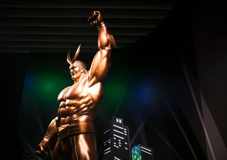 tokyo, japan - june 03 2021: Golden statue of the superhero All Might raising his fist in the air and standing at the exit of the My Hero Academia exhibition in Roppongi Hills.のeditorial素材
