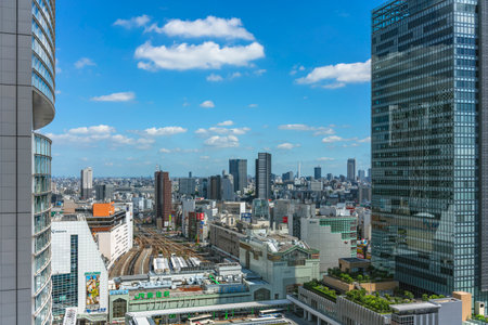 tokyo, japan - july 05 2021: Bird's-eye view of the South gate of the Japan Railway Shinjuku train station overlooked by the glassed facade of the JR Shinjuku Miraina Tower.のeditorial素材