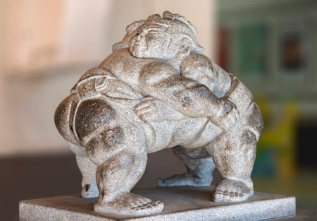 tokyo, japan - august 15 2021: Stone sculpture of two Japanese professional sumo wrestlers wrestling with a traditional chonmage haircut in their mawashi belt at the exit of the Ryogoku train station.のeditorial素材