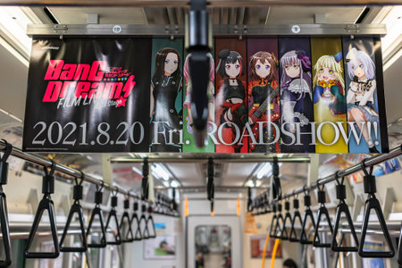 tokyo, japan - august 13 2021: Japanese advertising banners in a train promoting the anime movie roadshow of the Japanese music media franchise BanG Dream! also known as Bandori! with all characters.のeditorial素材