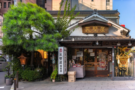 tokyo, japan - september 17 2019: Amanoya Cafe at Kanda-myÅjin famous for Amazake fermented rice drink with a traditional architecture adorned with ranma at doors and a portable Mikoshi Shinto shrine.のeditorial素材
