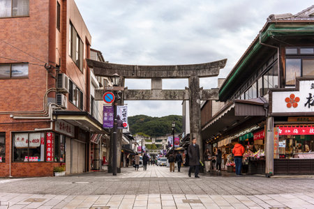 tokyo, japan - december 07 2020: Stone Torii portal at the entrance of the Dazaifu Tenmangu Sando Shopping street leading to the shintoist Japanese Dazaifu shrine dedicated to Sugawara no Michizane.のeditorial素材