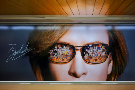 tokyo, japan - april 07 2019: Very large subway poster depicting the face of Japanese drummer and pianist Yoshiki from X Japan visual rock band producing the idols game THE iDOLM @ STER: SHINY COLORS.のeditorial素材