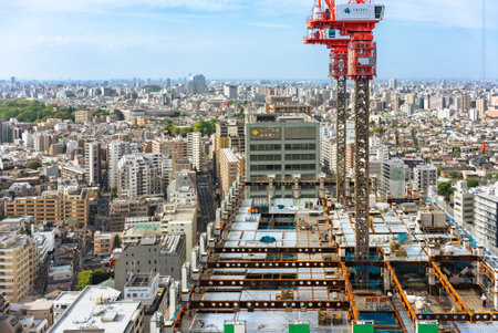 tokyo, japan - may 03 2019: Bunkyo Garden Gate Tower under construction with elevated cranes on top...