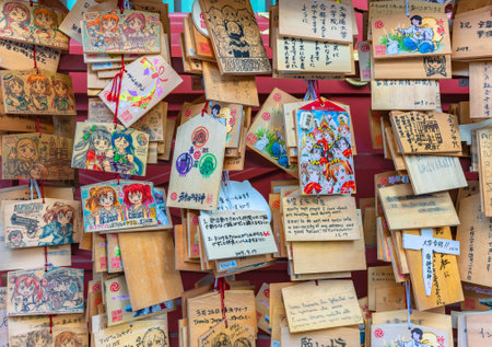 tokyo, japan - september 17 2019: Shinto timber votive plaques called Ema illustrated by worshipers with illustrations of tv anime characters in the Japanese Kanda Myojin shrine of Akihabara.のeditorial素材