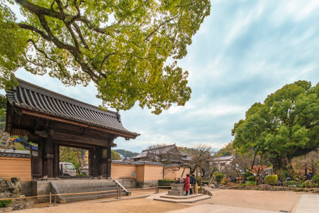 tokyo, japan - december 07 2019: Statue of ox that believers caress to heal in front of the Sanmon gate of the Enjuou-in temple in Dazaifu shrine famous for housing heroes of Meiji Restoration in 1865のeditorial素材