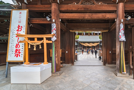 kyushu, japan - december 08 2021: Wooden miniature replica of a torii gate adorned with shinto sacred decorations made in dried straw called Shimenawa during Ooshime matsuri in the Miyajidake Shrine.のeditorial素材