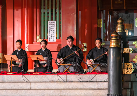tokyo, japan - december 15 2019: Japanese shamisen players performing at Edo Tokyo Yoichi or Night Market in Kanda Myojin shrine of Akihabara for tourists to experience traditional omatsuri festival.のeditorial素材